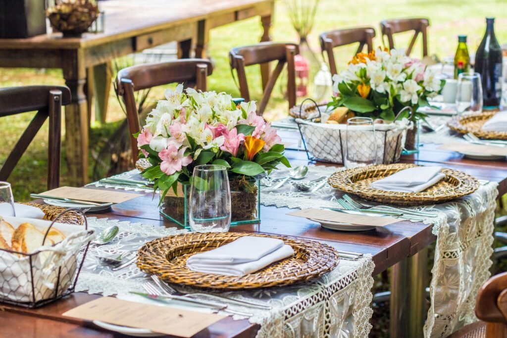 Chic outdoor dining setting with floral centerpieces and elegant tableware, perfect for special occasions.