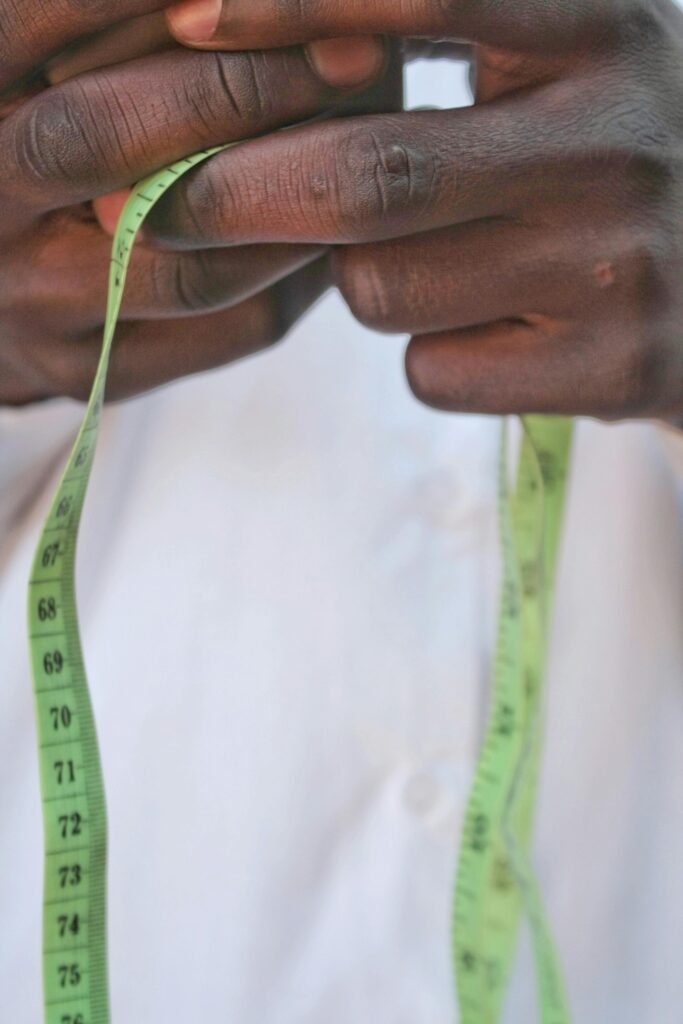 Detailed view of hands holding a measuring tape, focusing on precision.